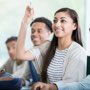 Female student raising hand in class