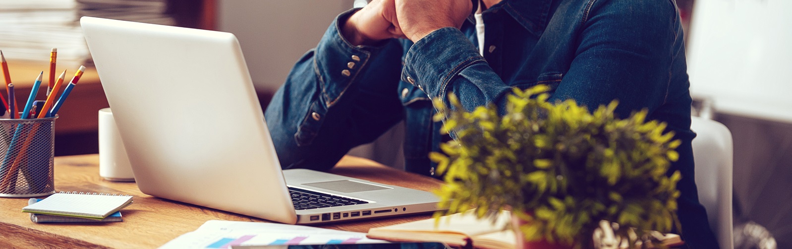 Man at a desk working on his laptop