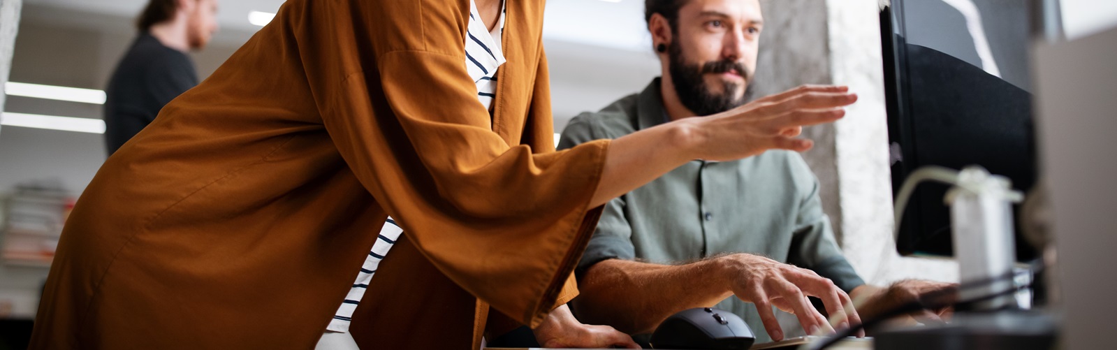 woman and a man working together on a project at a computer