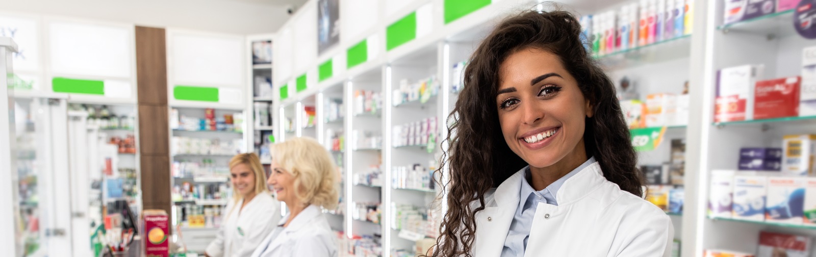 three female pharmacists standing at the pharmacy counter