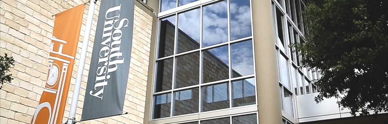 South University campus building with flag sign and windows