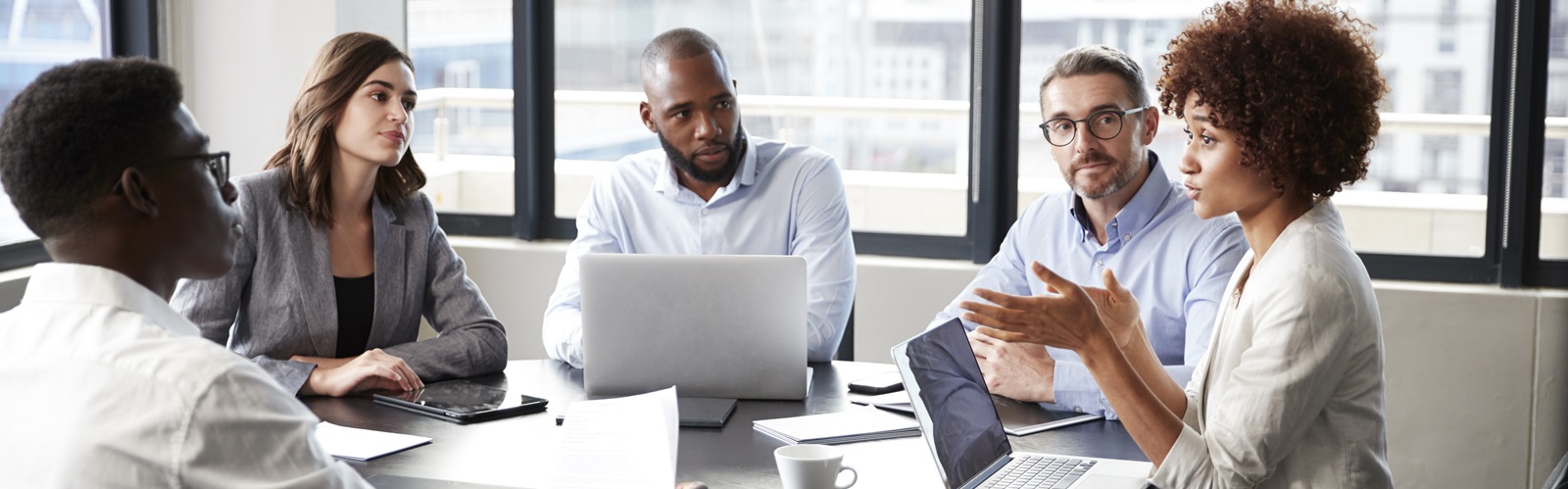 diverse group of professionals having a discussion at a conference table