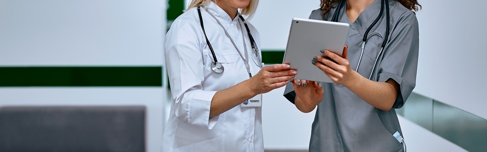 two women healthcare workers discussing findings on a tablet