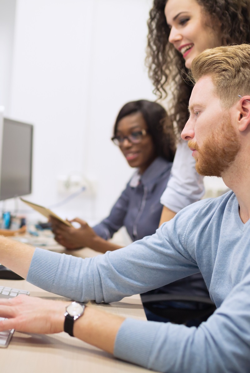 small group of professionals discussing code on a computer screen