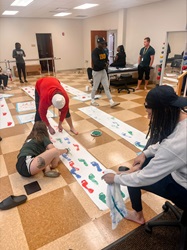 men and women in a physical therapy classroom working on gait lab