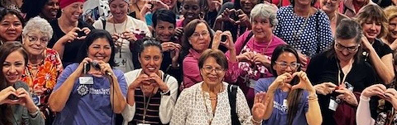 group of people posing for a photo at a breast cancer seminar