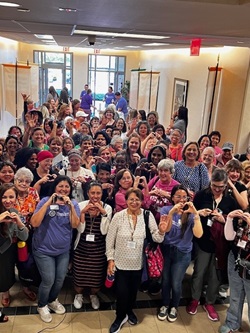 group of people posing for a photo at a breast cancer seminar