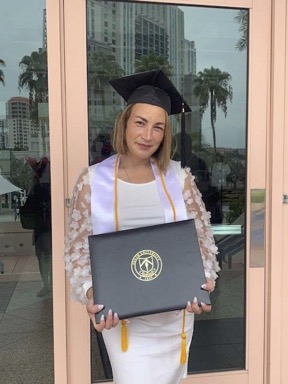 Melissa Neris-Soto posing at her graduation with her diplmoa