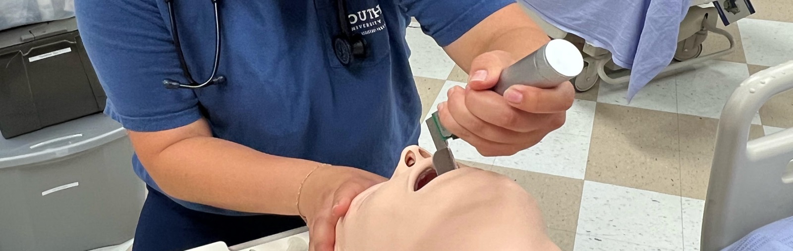 Andrea Reiter, a South University PA student, administering a procedure on a practice doll