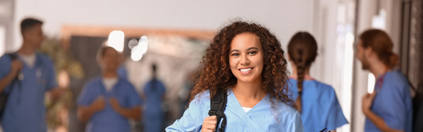 Nursing student in hallway with other students