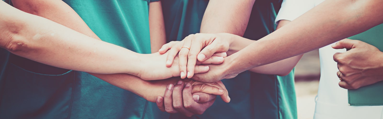 Group of nurses coordinate hands