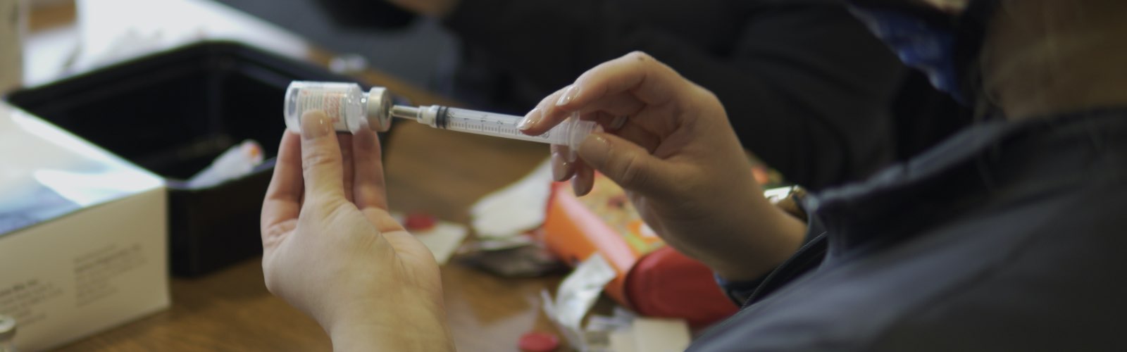 South University nursing student filling syringe with COVID Vaccine