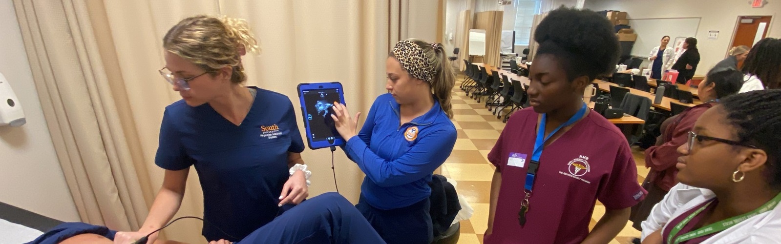 group of nursing students gather around to learn a new procedure