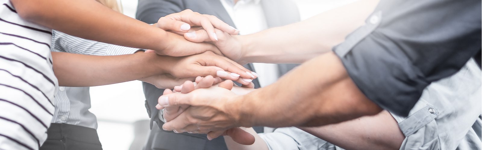 Group of people with hands stacked