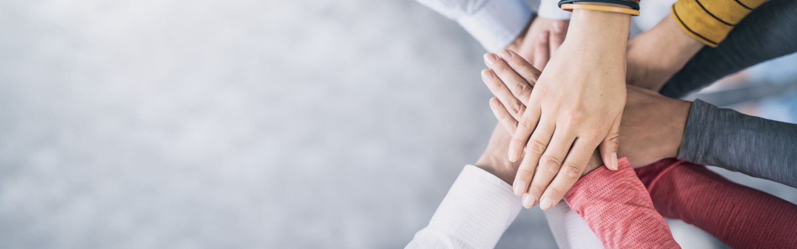 Group of business professionals with hands stacked