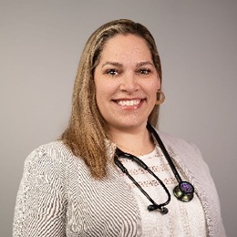 Brandi Galloway headshot in a beige sweater and stethiscope