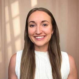 gabrielle giovati headshot in white blouse and long hair